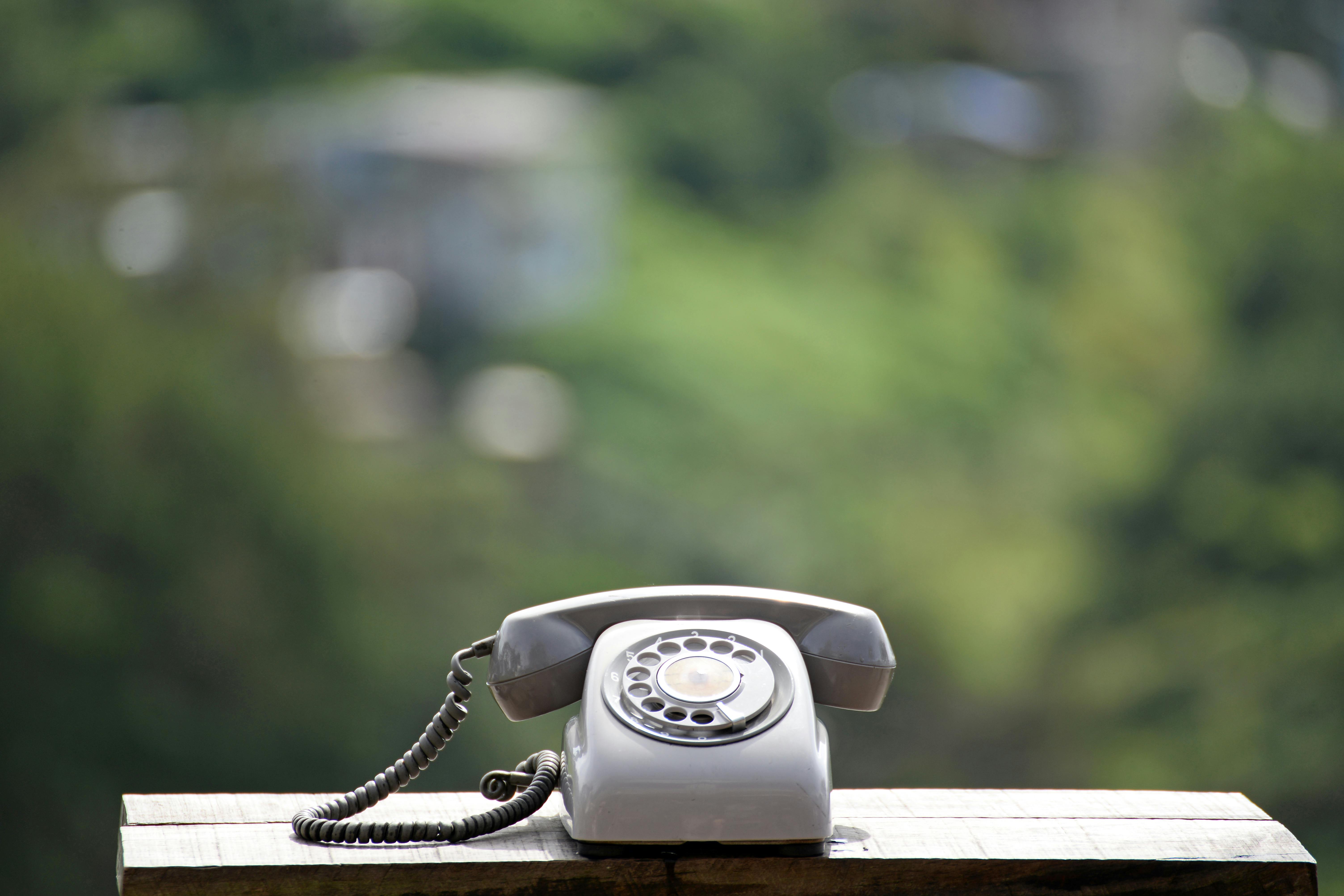 Picture of rotary telephone on table outside